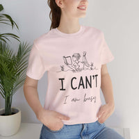 I Can’t, I’m Busy Unisex Jersey Short Sleeve TeeShow off your love for quiet moments with our I Can’t, I’m Busy Unisex Jersey Short Sleeve Tee. Perfect for book lovers and those who cherish their downtime, this tee features a playful illustration of a per