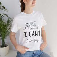 I Can’t, I’m Busy Unisex Jersey Short Sleeve TeeShow off your love for quiet moments with our I Can’t, I’m Busy Unisex Jersey Short Sleeve Tee. Perfect for book lovers and those who cherish their downtime, this tee features a playful illustration of a per