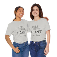 I Can’t, I’m Busy Unisex Jersey Short Sleeve TeeShow off your love for quiet moments with our I Can’t, I’m Busy Unisex Jersey Short Sleeve Tee. Perfect for book lovers and those who cherish their downtime, this tee features a playful illustration of a per