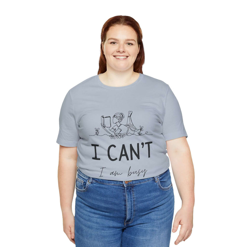 I Can’t, I’m Busy Unisex Jersey Short Sleeve TeeShow off your love for quiet moments with our I Can’t, I’m Busy Unisex Jersey Short Sleeve Tee. Perfect for book lovers and those who cherish their downtime, this tee features a playful illustration of a per