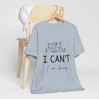 I Can’t, I’m Busy Unisex Jersey Short Sleeve TeeShow off your love for quiet moments with our I Can’t, I’m Busy Unisex Jersey Short Sleeve Tee. Perfect for book lovers and those who cherish their downtime, this tee features a playful illustration of a per