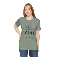 I Can’t, I’m Busy Unisex Jersey Short Sleeve TeeShow off your love for quiet moments with our I Can’t, I’m Busy Unisex Jersey Short Sleeve Tee. Perfect for book lovers and those who cherish their downtime, this tee features a playful illustration of a per