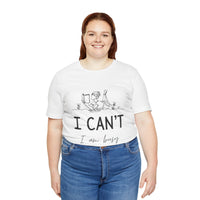 I Can’t, I’m Busy Unisex Jersey Short Sleeve TeeShow off your love for quiet moments with our I Can’t, I’m Busy Unisex Jersey Short Sleeve Tee. Perfect for book lovers and those who cherish their downtime, this tee features a playful illustration of a per