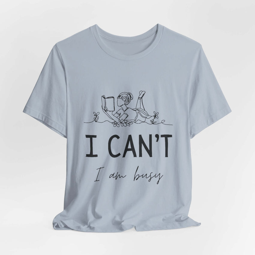 I Can’t, I’m Busy Unisex Jersey Short Sleeve TeeShow off your love for quiet moments with our I Can’t, I’m Busy Unisex Jersey Short Sleeve Tee. Perfect for book lovers and those who cherish their downtime, this tee features a playful illustration of a per