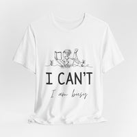 I Can’t, I’m Busy Unisex Jersey Short Sleeve TeeShow off your love for quiet moments with our I Can’t, I’m Busy Unisex Jersey Short Sleeve Tee. Perfect for book lovers and those who cherish their downtime, this tee features a playful illustration of a per