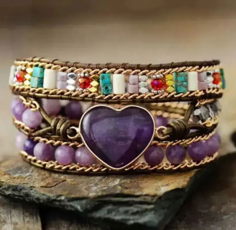 Amethyst Heart Wrap Bracelet Elevate your style with our Amethyst Heart Wrap Bracelet, crafted from genuine amethyst stones. This stunning piece features a unique heart design, promoting love and healing energy. Perfect for any occasion, it complements bo