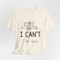 I Can’t, I’m Busy Unisex Jersey Short Sleeve TeeShow off your love for quiet moments with our I Can’t, I’m Busy Unisex Jersey Short Sleeve Tee. Perfect for book lovers and those who cherish their downtime, this tee features a playful illustration of a per