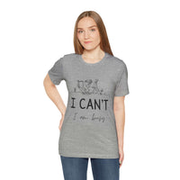 I Can’t, I’m Busy Unisex Jersey Short Sleeve TeeShow off your love for quiet moments with our I Can’t, I’m Busy Unisex Jersey Short Sleeve Tee. Perfect for book lovers and those who cherish their downtime, this tee features a playful illustration of a per