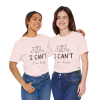 I Can’t, I’m Busy Unisex Jersey Short Sleeve TeeShow off your love for quiet moments with our I Can’t, I’m Busy Unisex Jersey Short Sleeve Tee. Perfect for book lovers and those who cherish their downtime, this tee features a playful illustration of a per