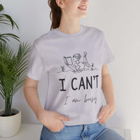 I Can’t, I’m Busy Unisex Jersey Short Sleeve TeeShow off your love for quiet moments with our I Can’t, I’m Busy Unisex Jersey Short Sleeve Tee. Perfect for book lovers and those who cherish their downtime, this tee features a playful illustration of a per