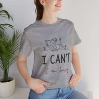 I Can’t, I’m Busy Unisex Jersey Short Sleeve TeeShow off your love for quiet moments with our I Can’t, I’m Busy Unisex Jersey Short Sleeve Tee. Perfect for book lovers and those who cherish their downtime, this tee features a playful illustration of a per