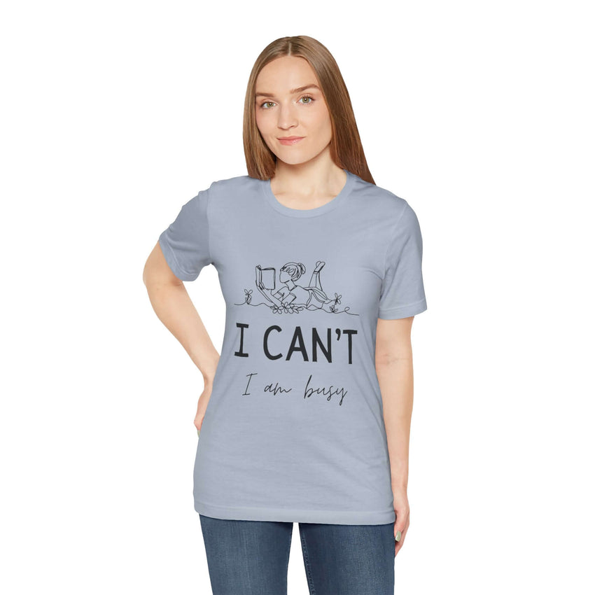 I Can’t, I’m Busy Unisex Jersey Short Sleeve TeeShow off your love for quiet moments with our I Can’t, I’m Busy Unisex Jersey Short Sleeve Tee. Perfect for book lovers and those who cherish their downtime, this tee features a playful illustration of a per